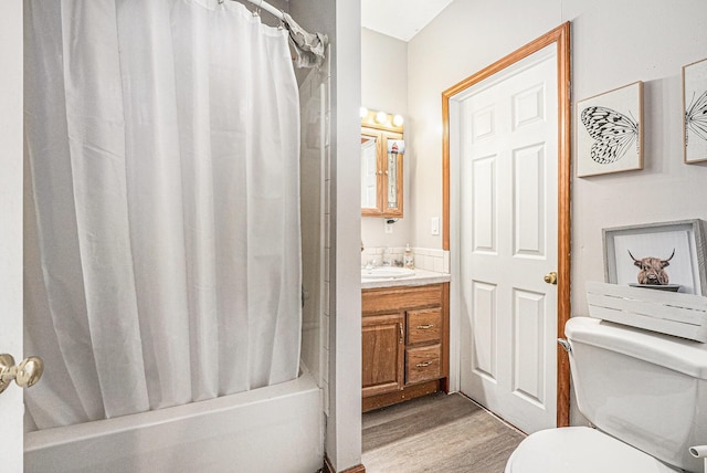 full bathroom with shower / tub combo, toilet, wood finished floors, and vanity