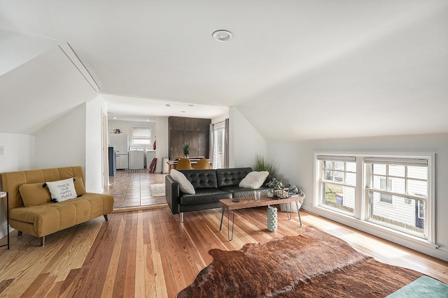 living room featuring light wood-style flooring and lofted ceiling