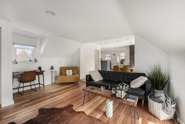 living room featuring recessed lighting, baseboards, lofted ceiling, and wood finished floors