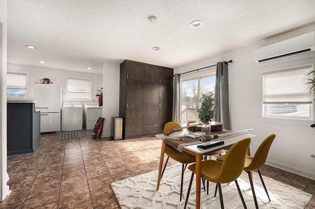 dining area featuring washer and dryer, an AC wall unit, recessed lighting, and baseboards