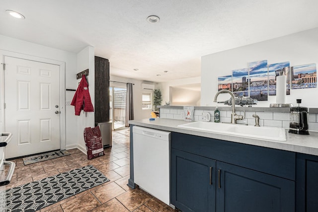 kitchen featuring light countertops, recessed lighting, white dishwasher, blue cabinets, and a sink