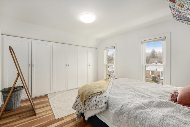 bedroom with light wood-type flooring and a closet