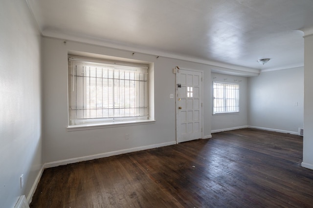 foyer entrance featuring visible vents, baseboards, and wood finished floors