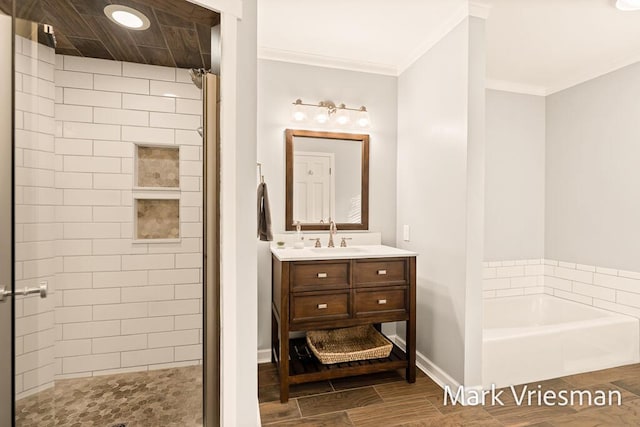 full bath with tiled shower, crown molding, baseboards, a bath, and vanity