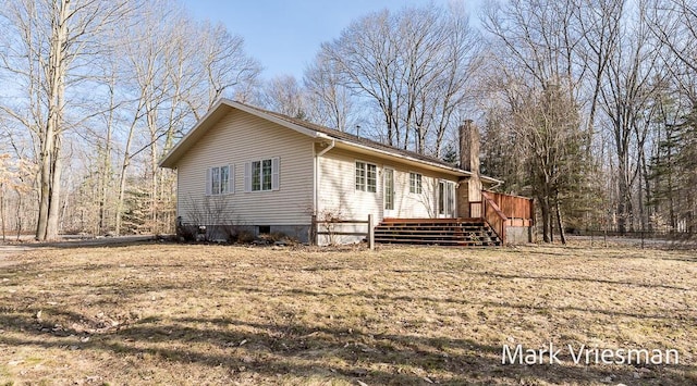 view of home's exterior featuring a wooden deck