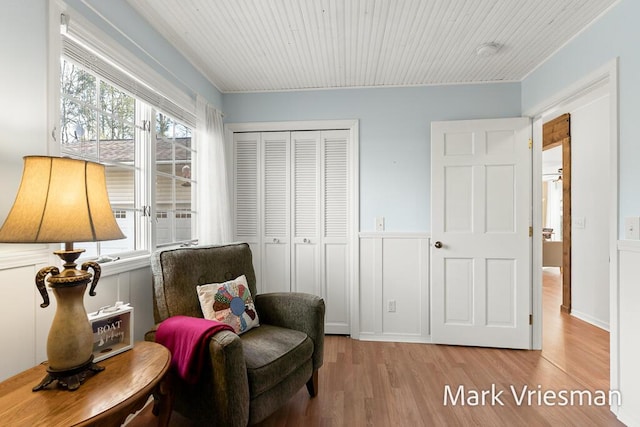 living area with wood ceiling and wood finished floors