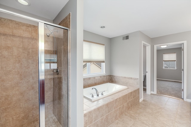 full bathroom with tile patterned floors, a garden tub, a shower stall, baseboards, and visible vents