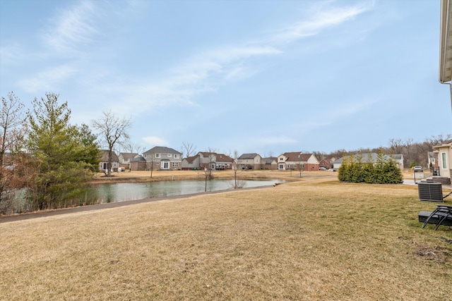 view of yard featuring a water view and a residential view