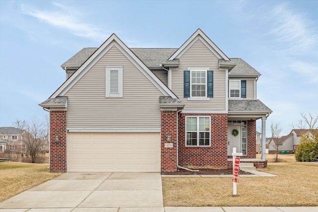 traditional-style house with brick siding, a front yard, concrete driveway, and a garage