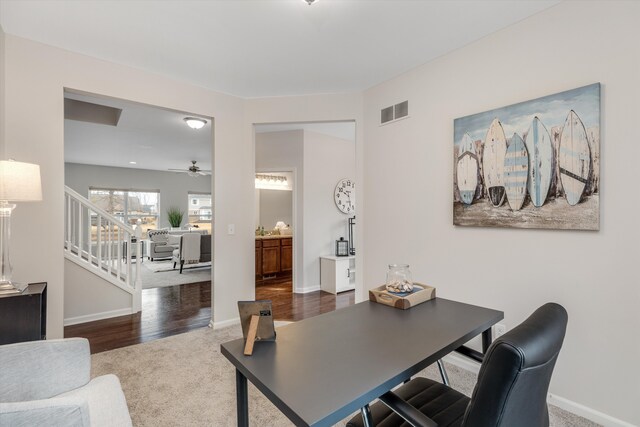 office featuring baseboards, visible vents, ceiling fan, and carpet flooring