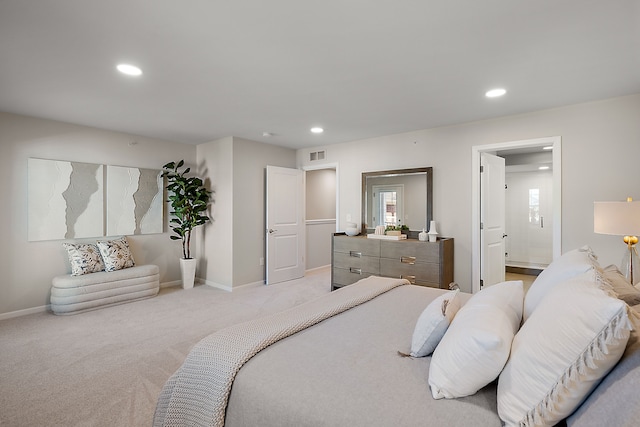 bedroom with recessed lighting, visible vents, light carpet, and baseboards