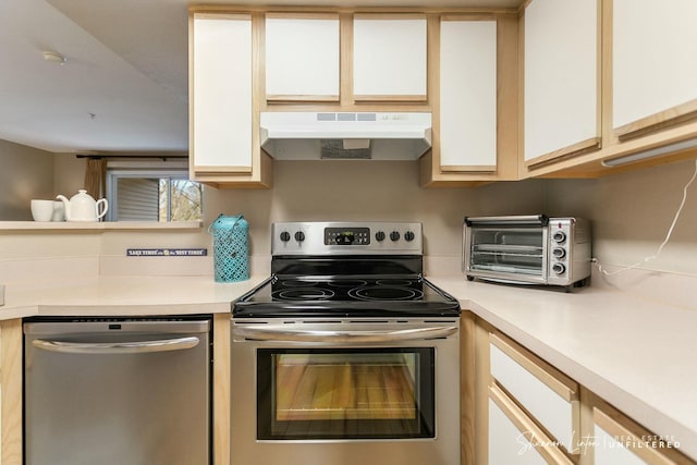 kitchen featuring under cabinet range hood, white cabinets, stainless steel appliances, and light countertops