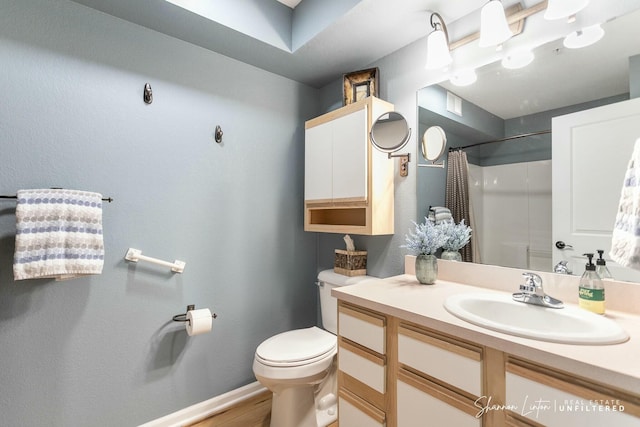 full bathroom with vanity, wood finished floors, baseboards, curtained shower, and toilet