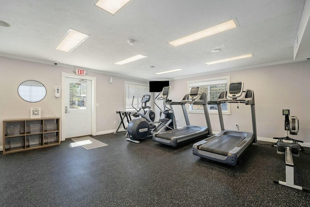 exercise room featuring baseboards and a textured ceiling