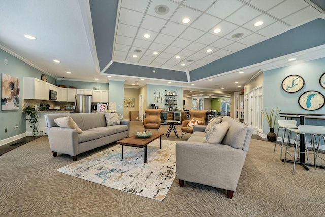 living area with light carpet, recessed lighting, and ornamental molding