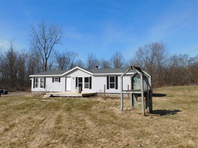 view of front of house with a deck and a front lawn