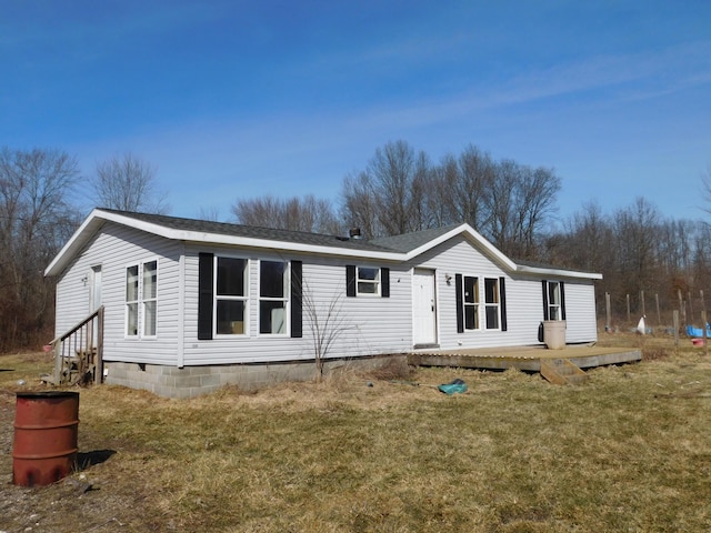 view of front of property with a deck, a front lawn, and entry steps