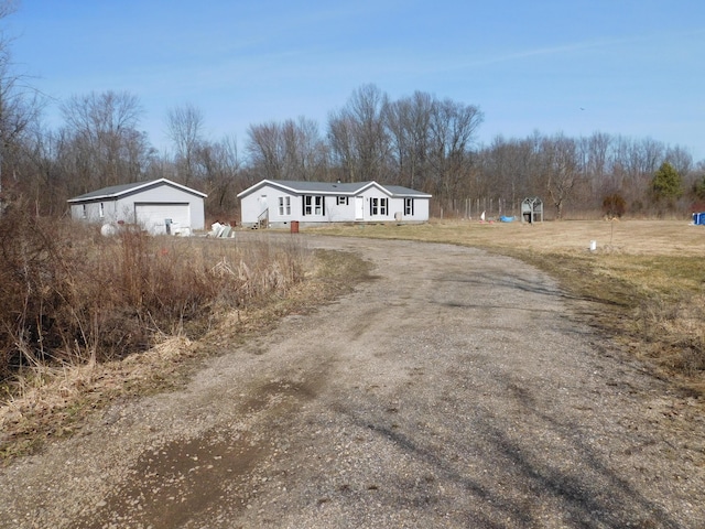 view of front of property with an outbuilding and a detached garage