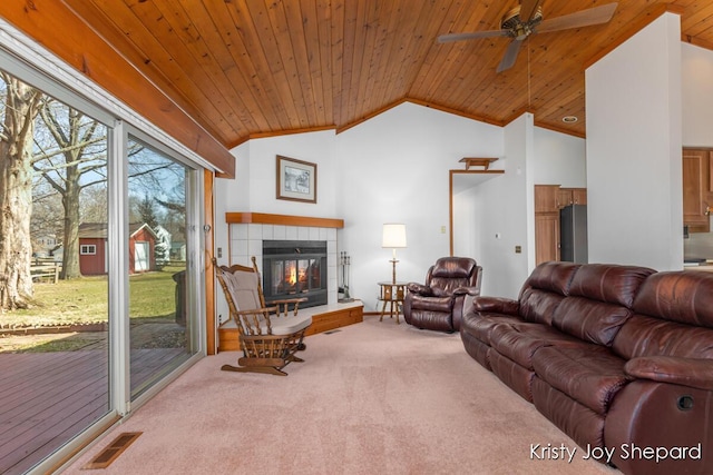 living area with carpet, visible vents, a fireplace, vaulted ceiling, and wood ceiling