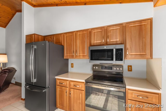 kitchen with stainless steel appliances, brown cabinetry, light countertops, wood ceiling, and vaulted ceiling