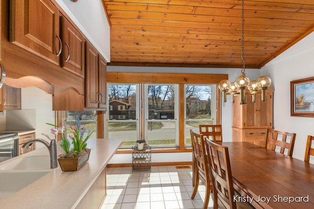 dining room featuring an inviting chandelier, wooden ceiling, light tile patterned floors, and lofted ceiling