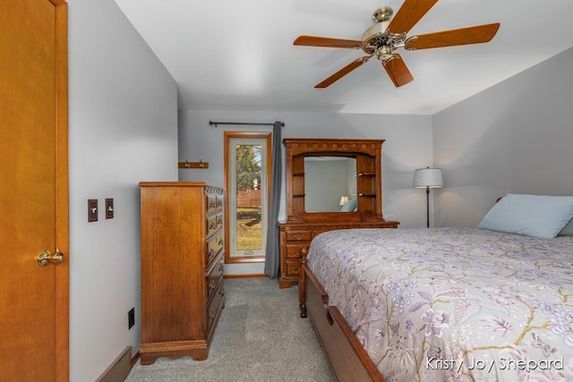 carpeted bedroom featuring baseboards and ceiling fan