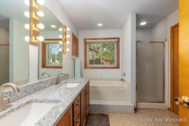 full bath with a shower stall, a garden tub, double vanity, and a sink