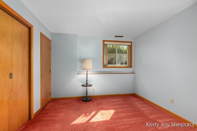 unfurnished bedroom with visible vents, baseboards, and carpet