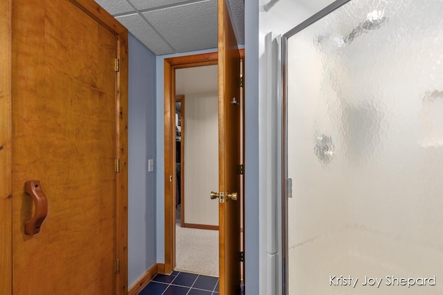 full bathroom with a drop ceiling, baseboards, a stall shower, and tile patterned flooring