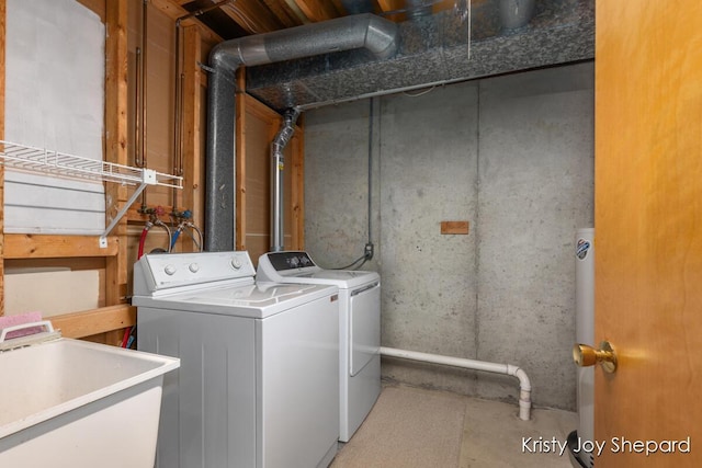 laundry room featuring laundry area, washing machine and dryer, and a sink