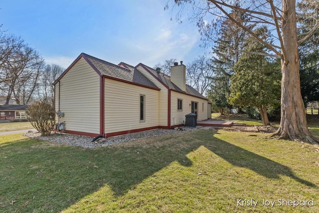 view of property exterior featuring a chimney and a yard