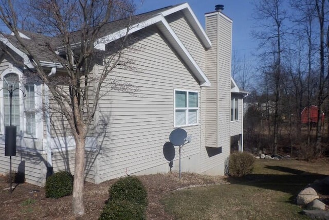 view of property exterior with a chimney