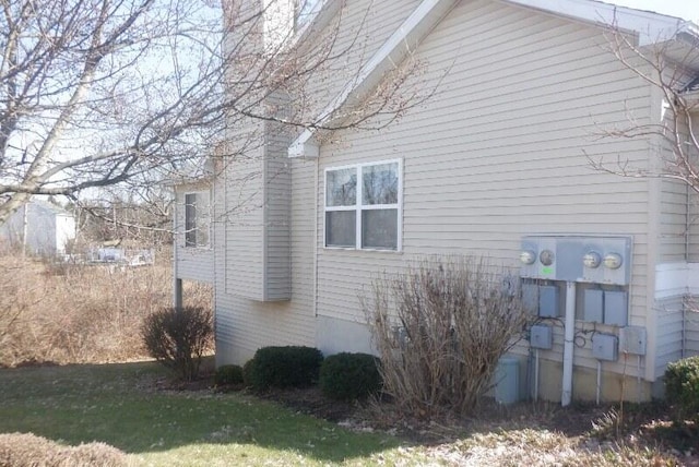 view of side of property with a lawn