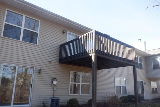 rear view of house featuring central AC