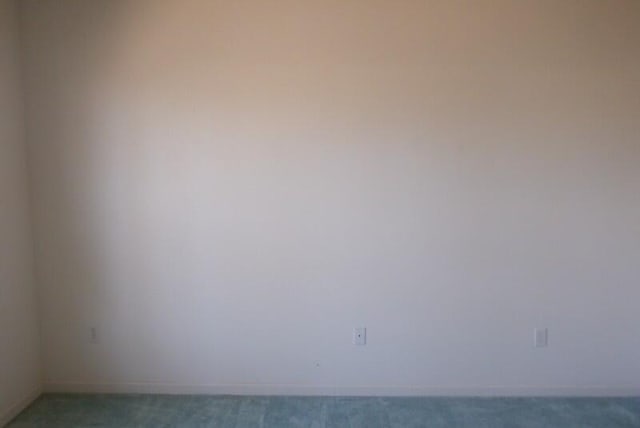 empty room with baseboards and carpet floors