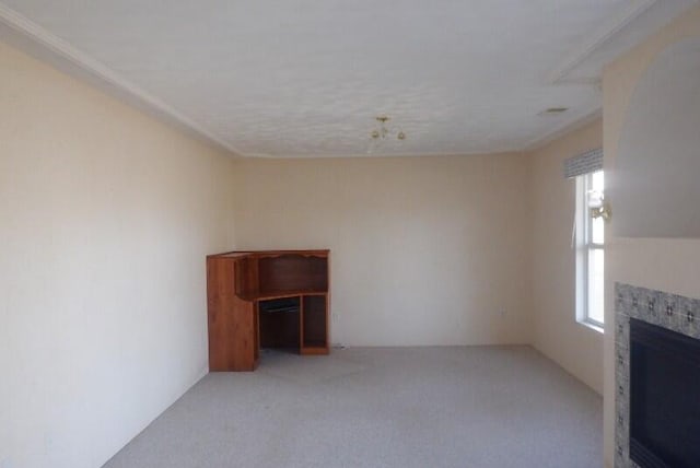 unfurnished living room featuring light colored carpet and a tile fireplace