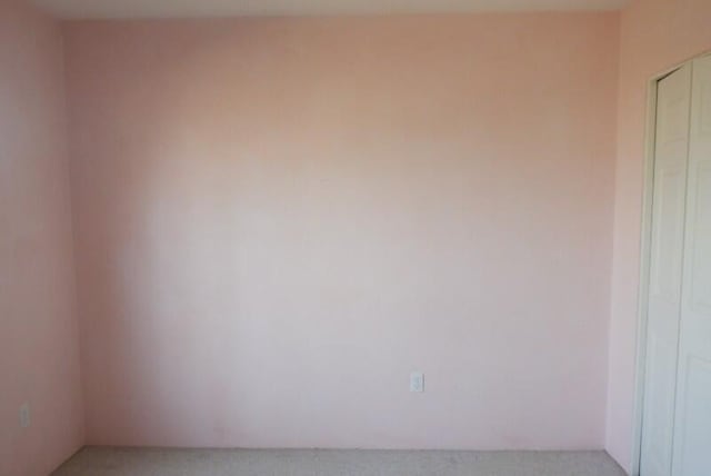 unfurnished room featuring light colored carpet