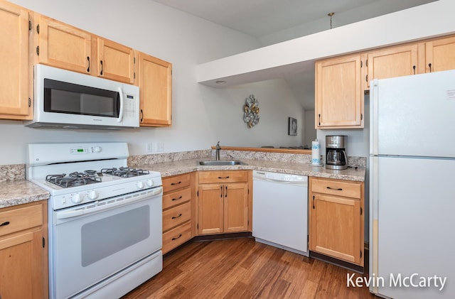 kitchen featuring light brown cabinets, white appliances, dark wood-type flooring, and a sink