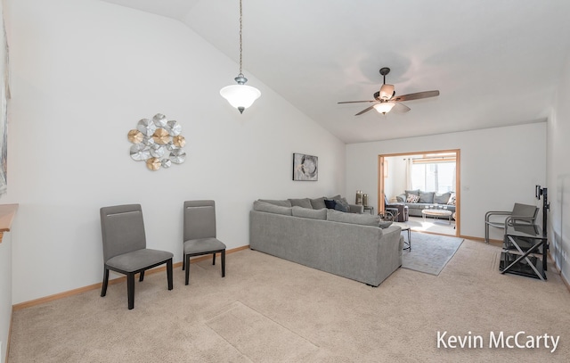 living area featuring carpet, baseboards, and ceiling fan