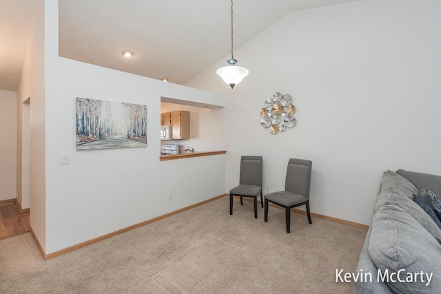 sitting room featuring baseboards, carpet floors, and high vaulted ceiling