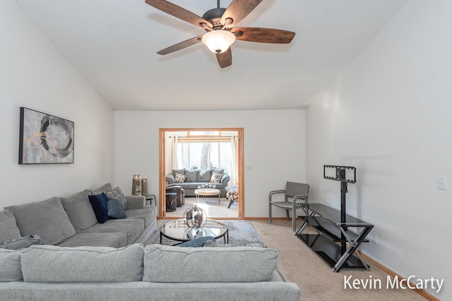 living area featuring vaulted ceiling, carpet flooring, a ceiling fan, and baseboards