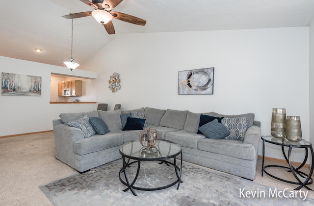 living room featuring carpet flooring, ceiling fan, baseboards, and lofted ceiling