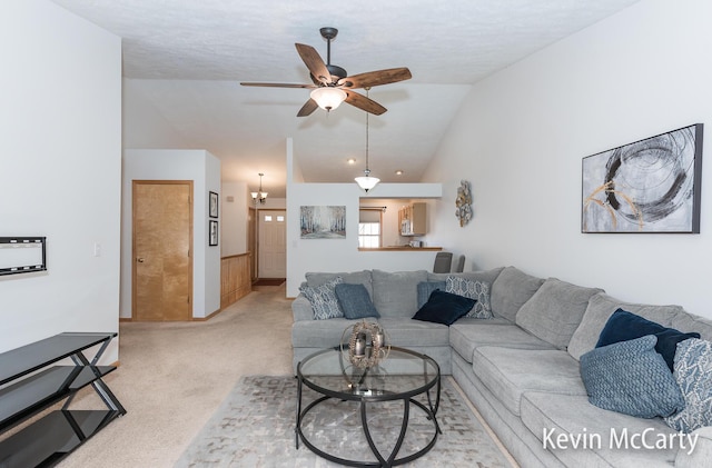 living area with a ceiling fan, light colored carpet, and high vaulted ceiling