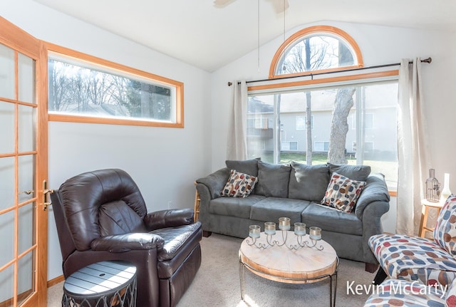 carpeted living room featuring lofted ceiling