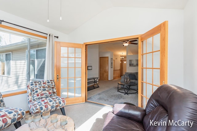 living room with a ceiling fan and lofted ceiling