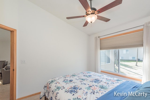 bedroom with baseboards, carpet floors, lofted ceiling, and a ceiling fan