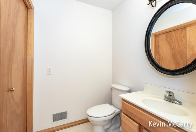 bathroom with vanity, toilet, and visible vents