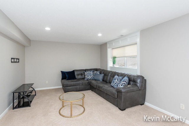 carpeted living area with recessed lighting and baseboards