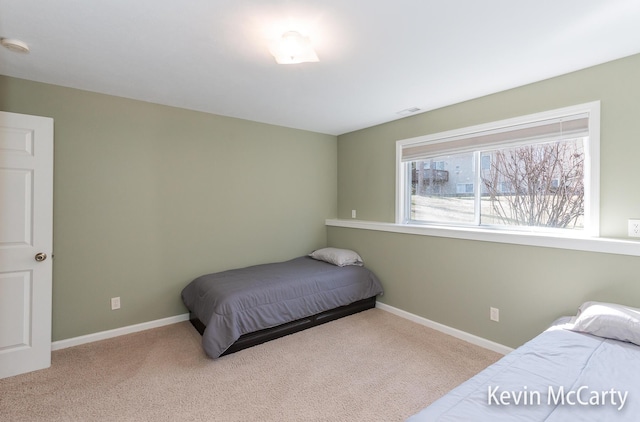 bedroom featuring baseboards and carpet