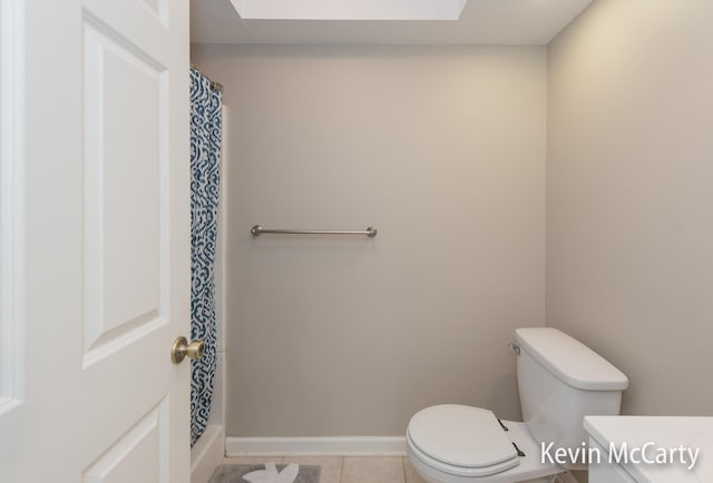 full bath with tile patterned floors, baseboards, toilet, and a shower with shower curtain